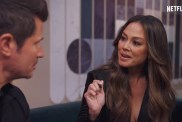 Vanessa Lachey holding a pen and talking to Nick Lachey