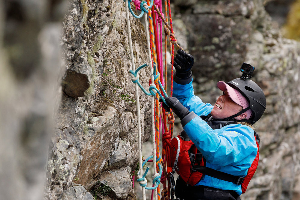 Heather from Race to Survive: New Zealand climbing up the side of a rock