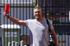 Mauricio Umansky in a grey t-shirt holding up a red cup