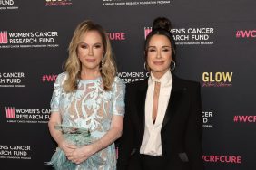 Kathy Hilton in a blue dress posing with Kyle Richards who is wearing a black suit