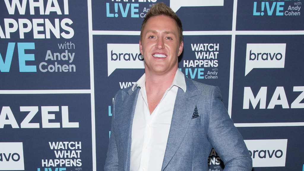 Kroy Biermann in a blue suit posing backstage at Watch What Happens Live