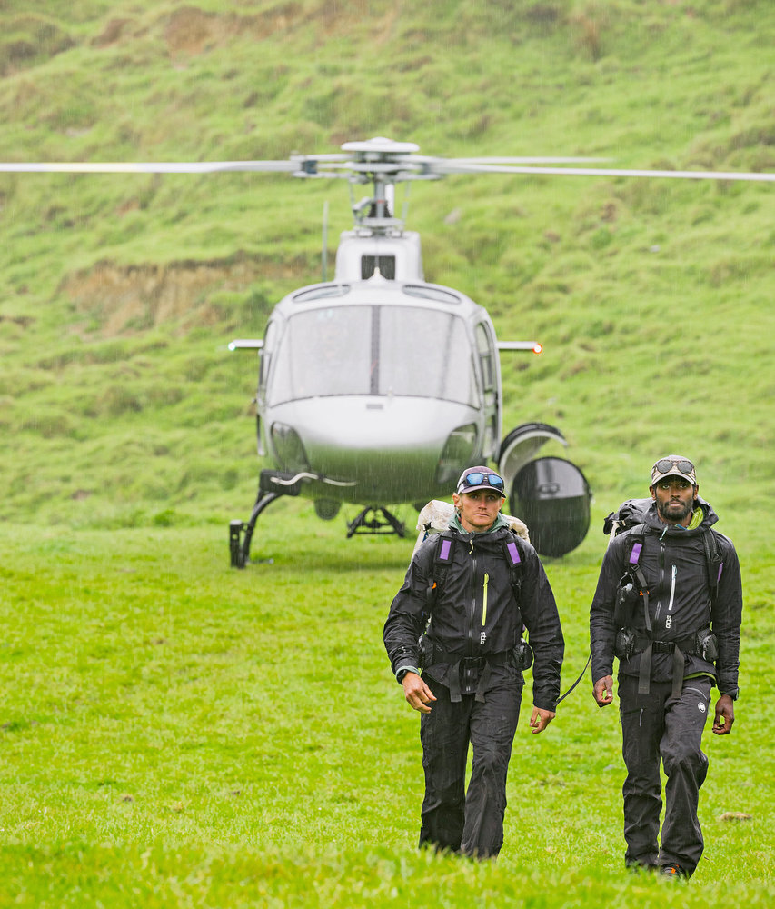 Oliver and Corry walking away from a helicopter on Race to Survive: New Zealand