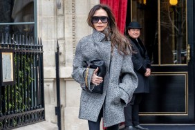 Victoria Beckham in a grey coat holding a clutch