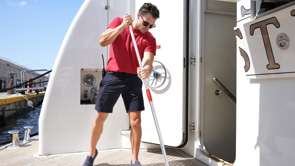 Joe Bradley scrubbing the deck on Below Deck Med.