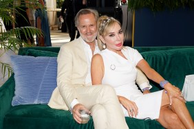 Marysol Patton and Steve McNamara pose together on a green couch