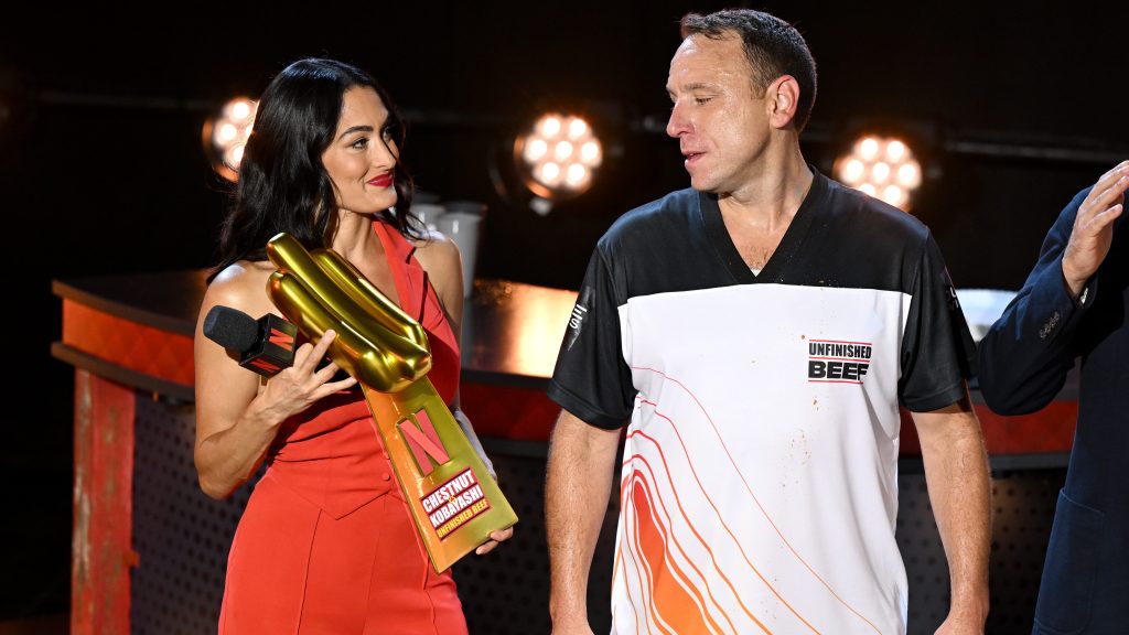 Nikki Garcia with Joey Chestnut at a hotdog eating competition.