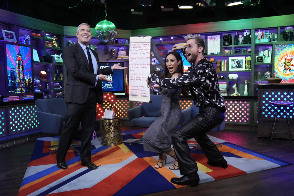 Angie K presenting her scroll to Andy Cohen with Lance Bass on WWHL.