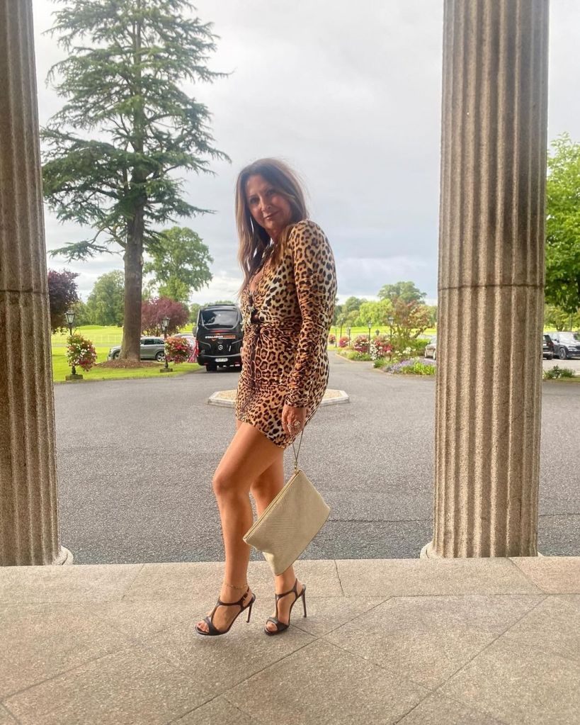 Fran Cutler posing in a cheetah-print dress