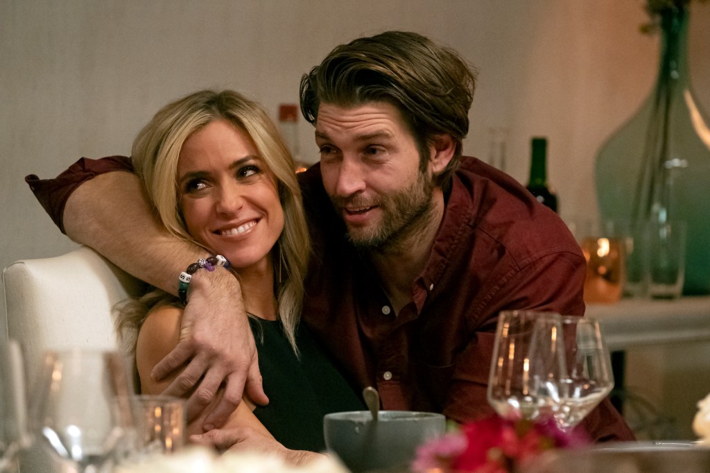 Kristin Cavallari and Jay Cutler hugging at a dinner table