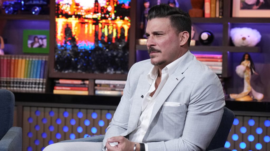 Jax Taylor looking pensive in a light-colored suit on WWHL.