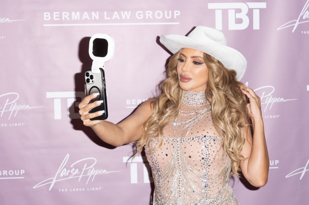 Larsa Pippen wearing a cowboy hat and taking a photo of herself.