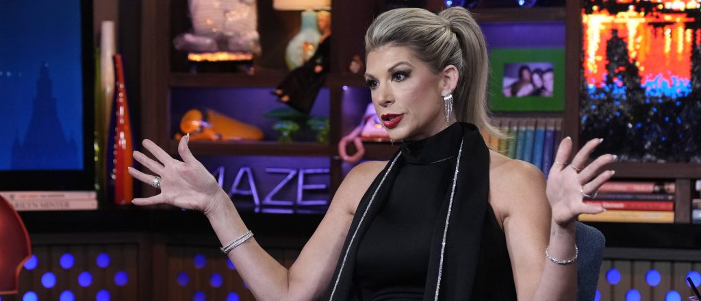 RHOC star Alexis Bellino with her hands in the air on WWHL.