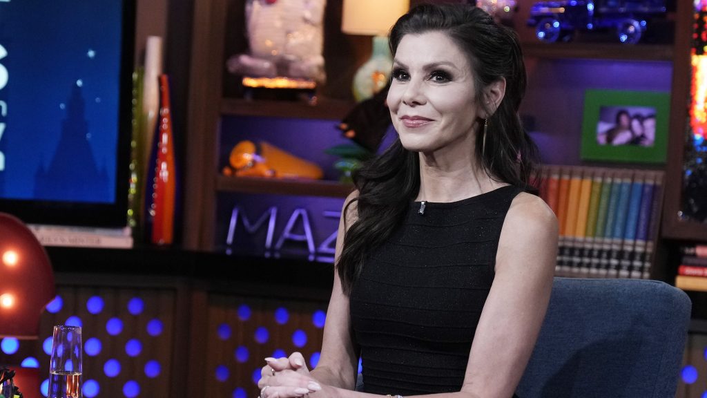 RHOC legend Heather Dubrow wearing black and sitting with her hands in her lap on WWHL.