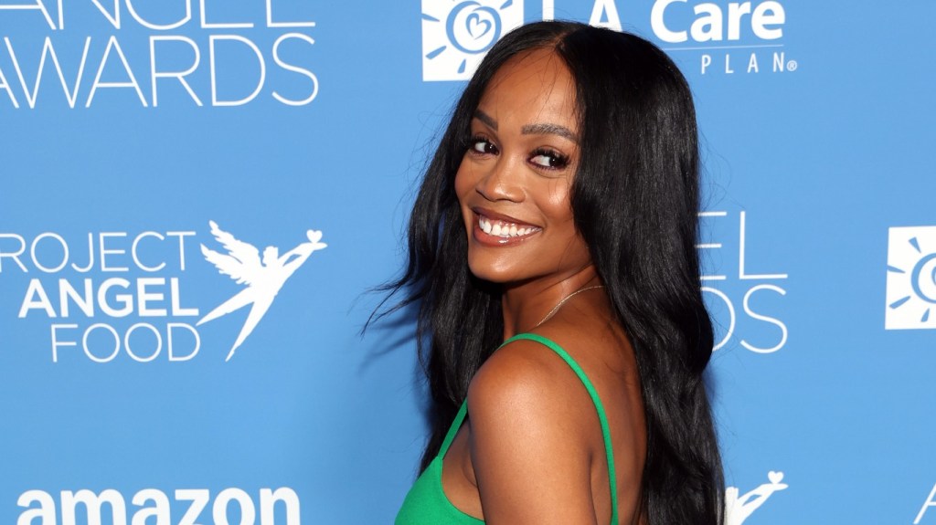 Rachel Lindsay in a green dress doing an over the shoulder pose