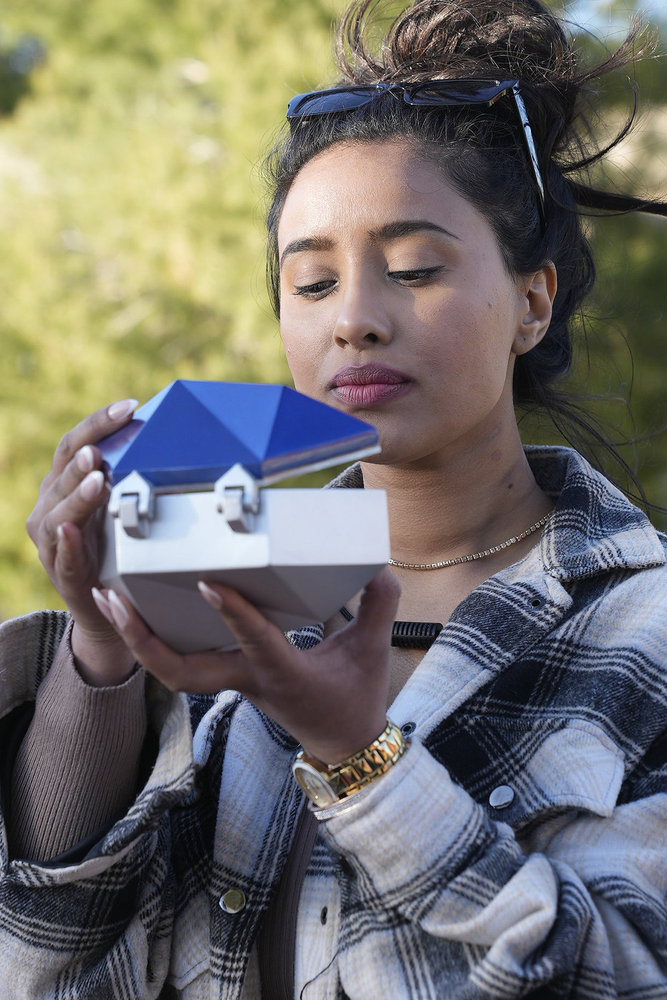 Bismah Ahmed opening a box during the face-off on The Anonymous 