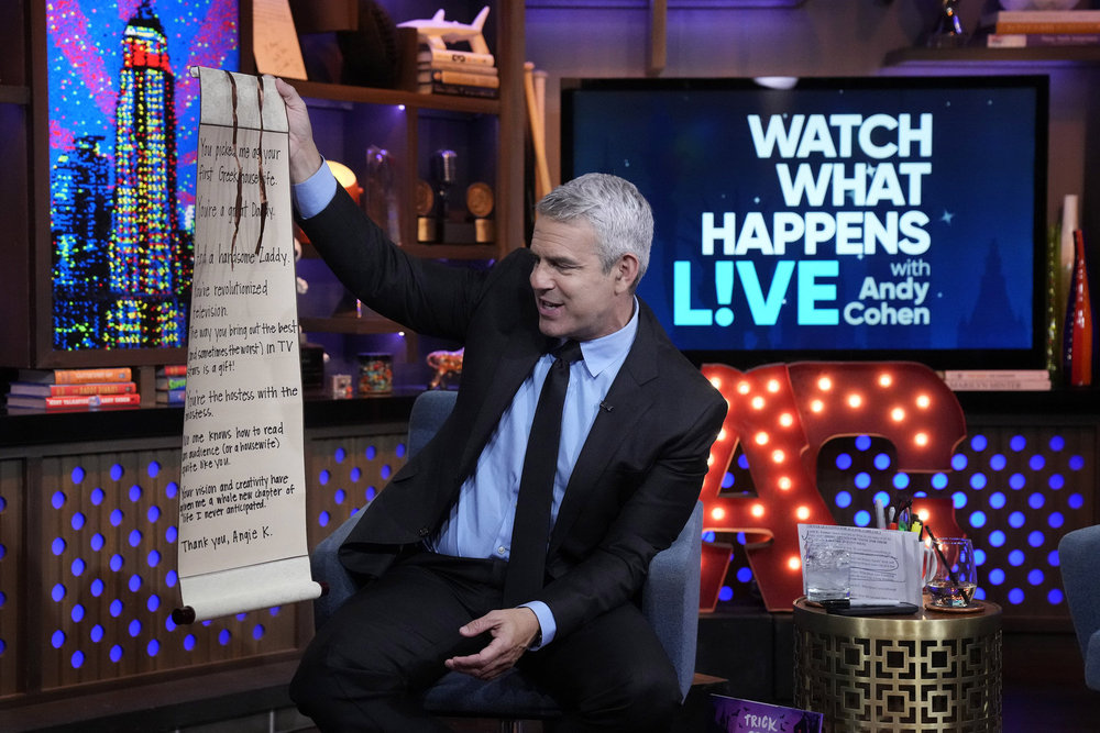 Andy Cohen looks at Angie K's scroll on WWHL.