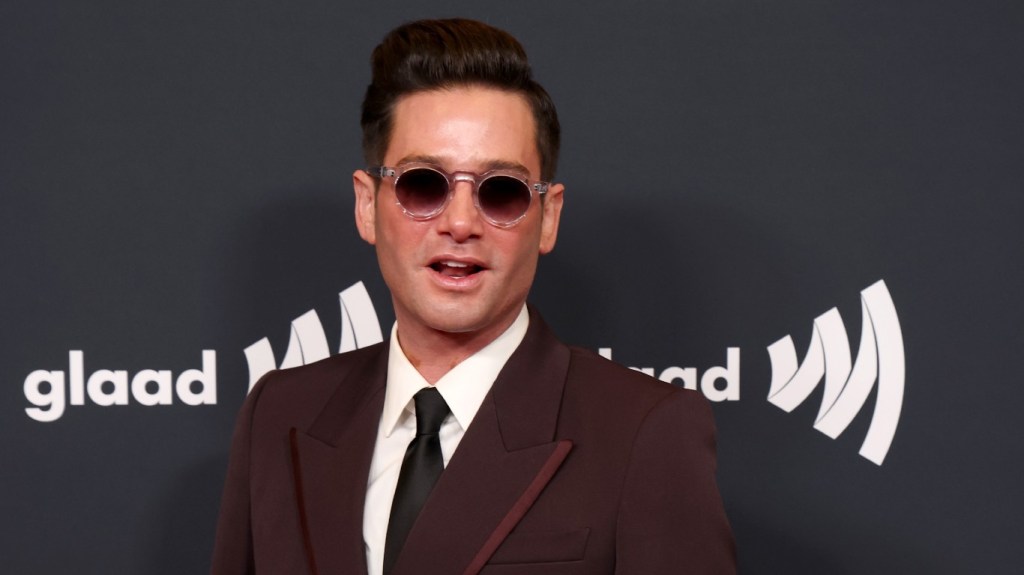Josh Flagg in sunglasses and a maroon suit at the GLAAD awards
