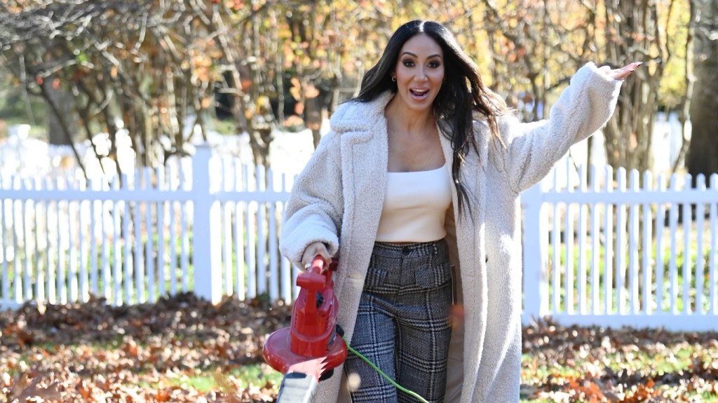 Melissa Gorga with a leaf blower