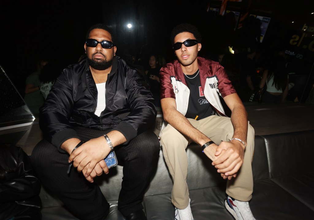 Preston Pippen wearing sunglasses and sitting with Arize at Billboard's No 1 Party