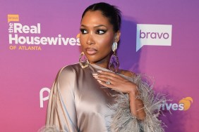 Brit Eady in a silver dress with her hand over her heart