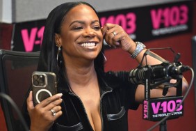 Kandi Burruss in a radio studio holding an iPhone