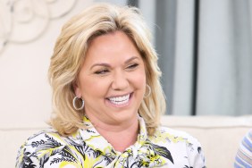 Julie Chrisley smiling and wearing a white and yellow shirt